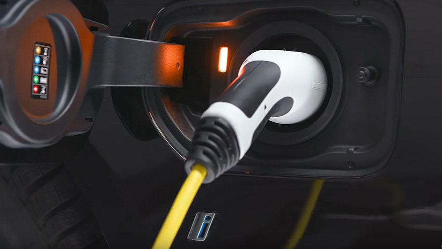 BMW plug-in hybrid connected with charging cable BMW 2 Series Active Tourer F45 BMW plug-in hybrid connected with charging cable close-up