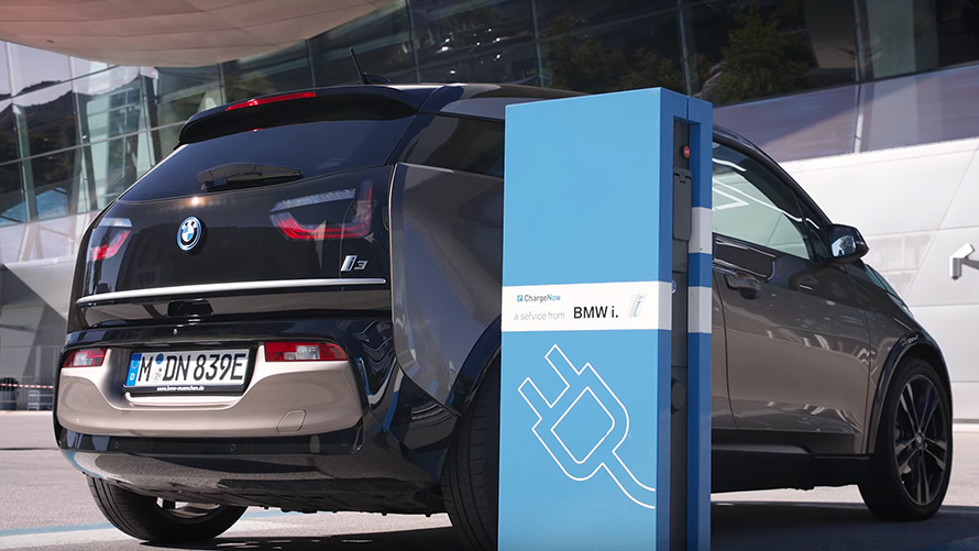 BMW i3 on charging station BMW 2 Series Active Tourer F45 BMW i3 at charging station three-quarter rear view