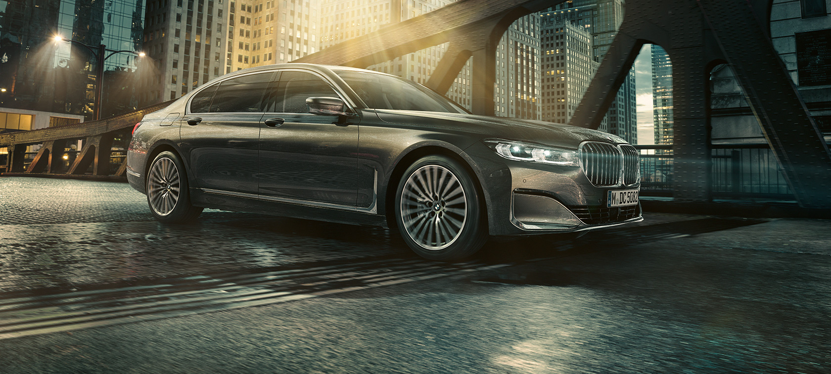 BMW 7 Series Sedan side view BMW 7 Series Sedan in side view with opened door in front of illuminated hotel
