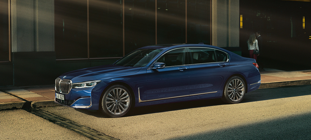 BMW Individual 7 Series Sedan, side view BMW Individual 7 Series Sedan in red in side view in front of urban setting