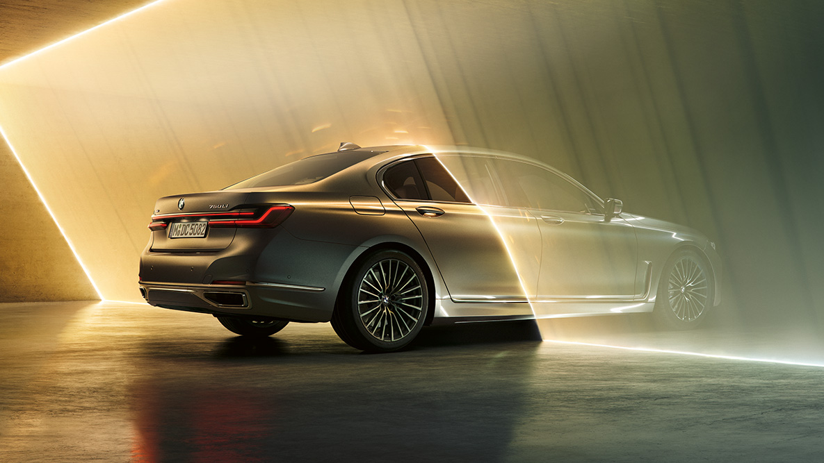 BMW 7 Series Sedan in Bernina Grey BMW 7 Series Sedan in Bernina Grey in three-quarter rear view surrounded by beam of light