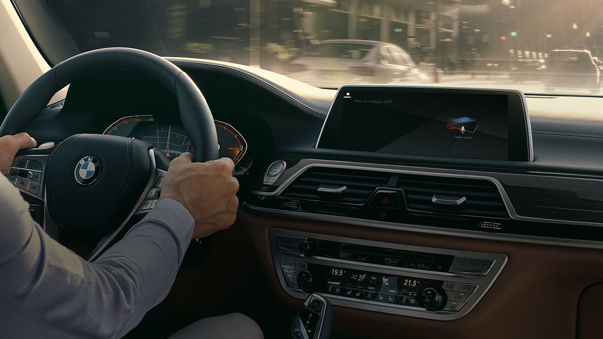 BMW Intelligent Personal Assistant BMW Intelligent Personal Assistant: man drives BMW, close-up of Live Cockpit Professional