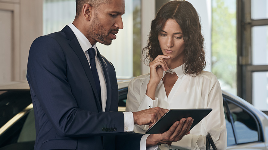 Women being advised by BMW employee Women being advised by BMW employee